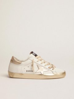 Women??s Super-Star sneakers with gold sparkle foxing and metal stud lettering